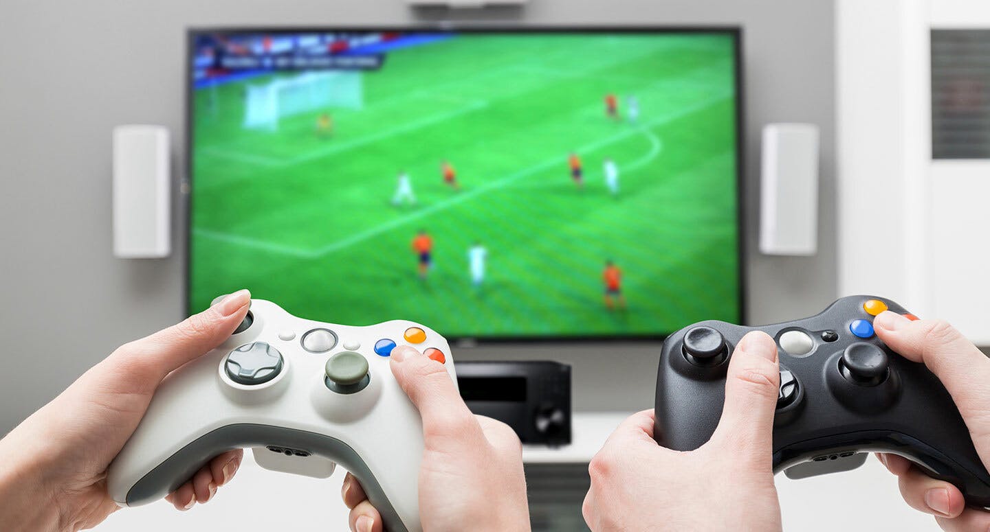 Onkyo TX-RZ40 AV Receiver under TV with people playing a soccer video game